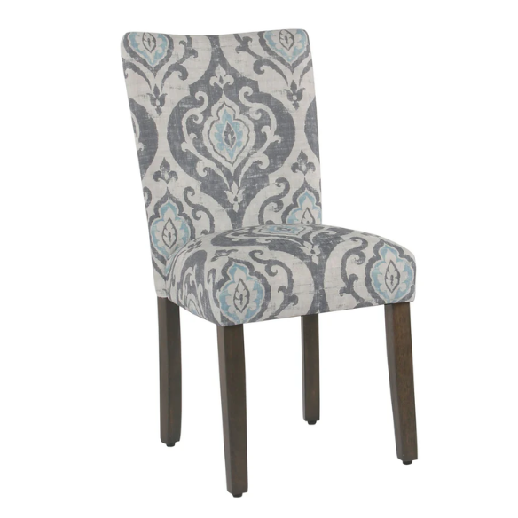 Set of two Parsons dining chairs with grey, white, and light blue floral upholstery, high back design, scalloped seat front, and wood legs