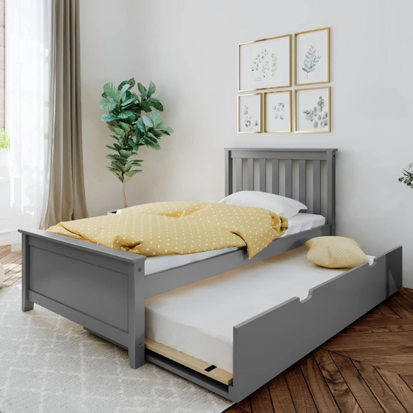 Grey solid wood twin bed with pull-out trundle, modern slatted headboard and footboard, perfect for kids’ rooms and overnight guests.