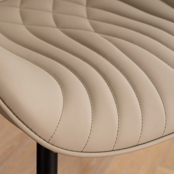 Set of 2 khaki faux leather dining chairs with fishtail tufted backs and black metal legs, styled for modern and transitional interiors.