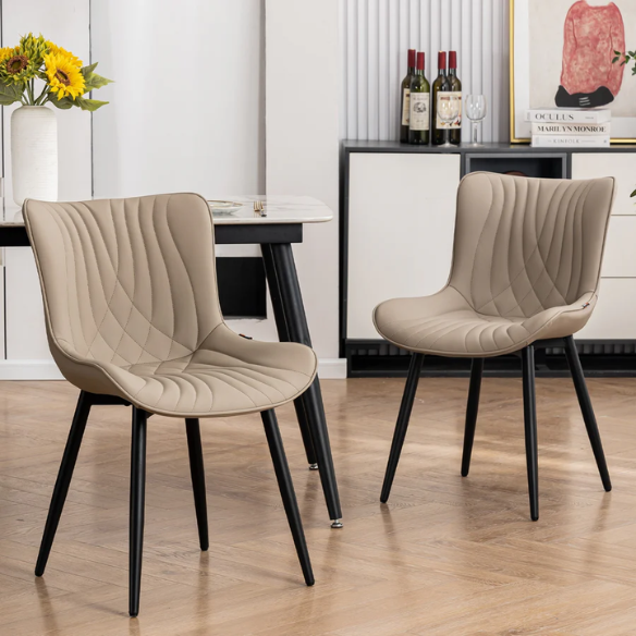 Set of 2 khaki faux leather dining chairs with fishtail tufted backs and black metal legs, styled for modern and transitional interiors.