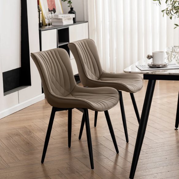 Set of 2 khaki faux leather dining chairs with fishtail tufted backs and black metal legs, styled for modern and transitional interiors.