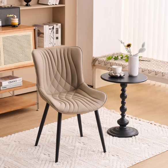 Set of 2 khaki faux leather dining chairs with fishtail tufted backs and black metal legs, styled for modern and transitional interiors.