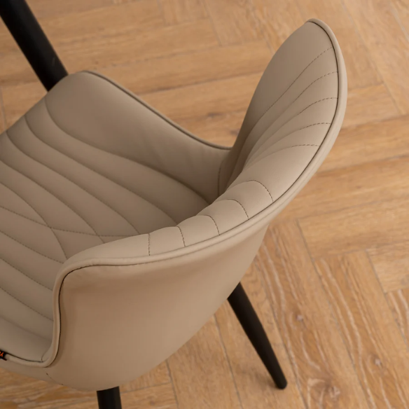 Set of 2 khaki faux leather dining chairs with fishtail tufted backs and black metal legs, styled for modern and transitional interiors.