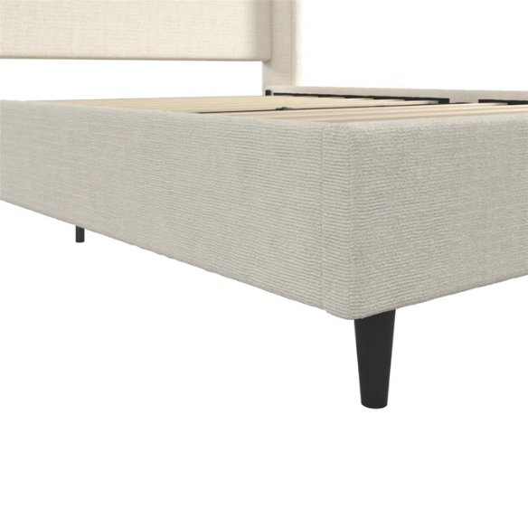 Light cream boucle queen-size platform bed with tall wingback tufted headboard and black tapered legs.