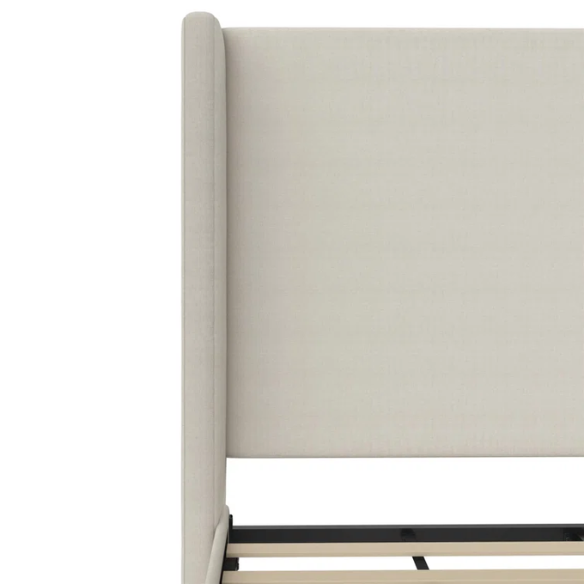 Light cream canvas upholstered queen-size bed with extra-tall wingback tufted headboard and black tapered legs.