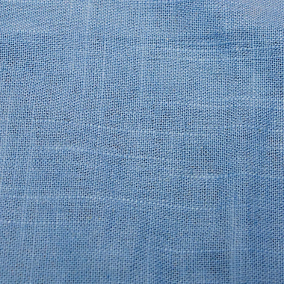 Light denim blue king-size upholstered bed in linen fabric with wingback headboard and low-profile black metal legs.