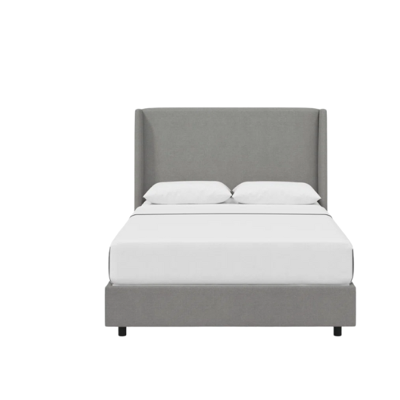 Light grey king-size upholstered bed in linen fabric with wingback headboard and low-profile black metal legs.