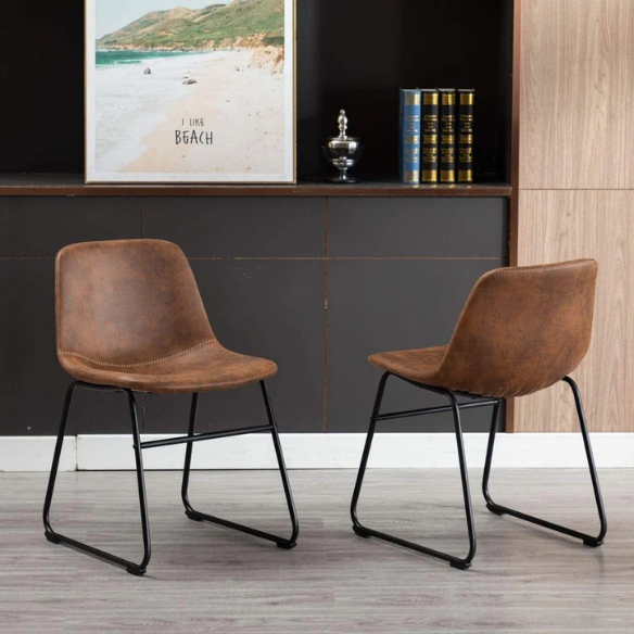 Set of two modern dining chairs upholstered in brown faux leather with curved backrests and black metal legs.