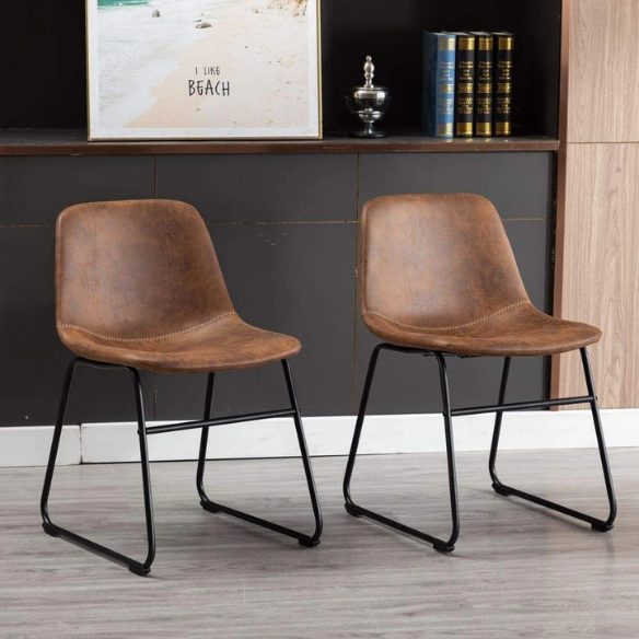Set of two modern dining chairs upholstered in brown faux leather with curved backrests and black metal legs.