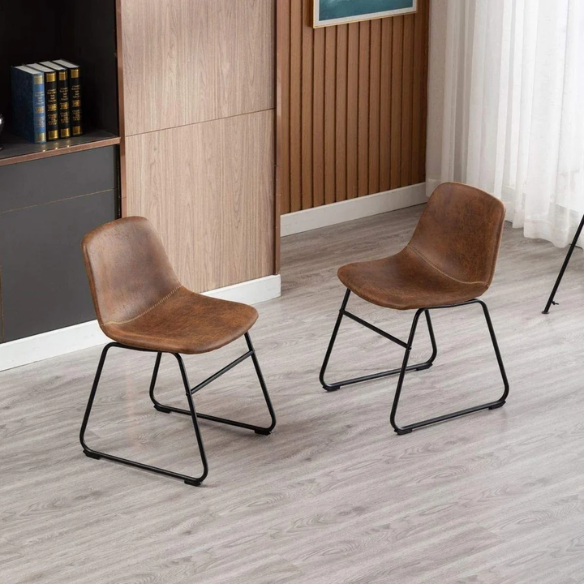 Set of two modern dining chairs upholstered in brown faux leather with curved backrests and black metal legs.