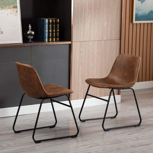 Set of two modern dining chairs upholstered in brown faux leather with curved backrests and black metal legs.