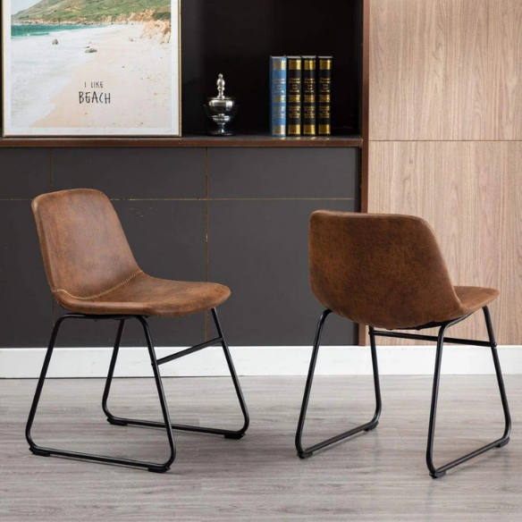Set of two modern dining chairs upholstered in brown faux leather with curved backrests and black metal legs.