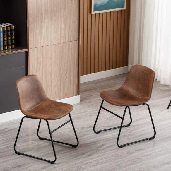 Set of two modern dining chairs upholstered in brown faux leather with curved backrests and black metal legs.