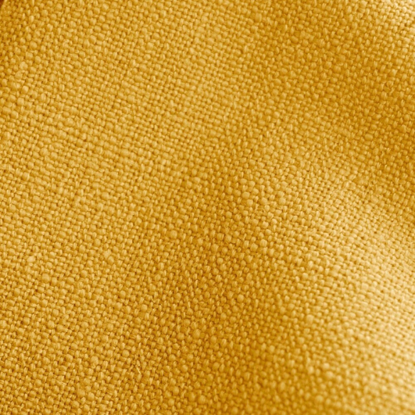Mustard yellow king-size upholstered bed in linen fabric with wingback headboard and low-profile black metal legs.