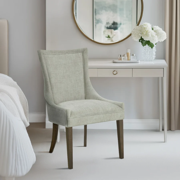Set of 2 upholstered armless dining chairs in muted green with solid wood legs, high backrest, and elegant piping detail.