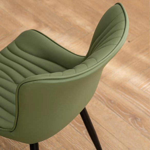 Set of 2 olive drab green faux leather dining chairs with fishtail backrest and metal legs, styled for a modern and mid-century inspired interior.