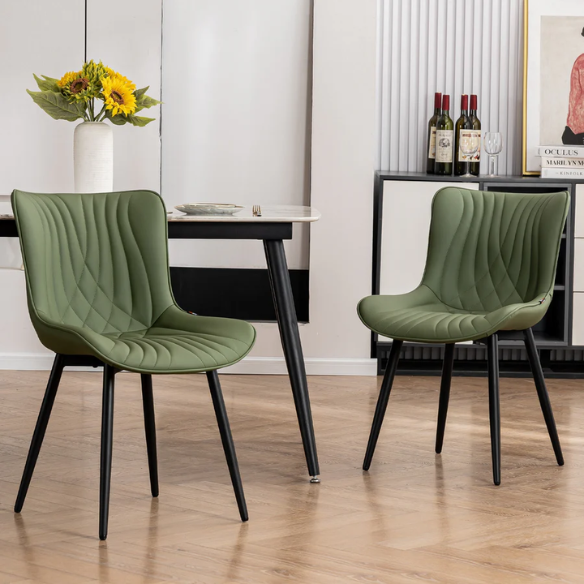 Set of 2 olive drab green faux leather dining chairs with fishtail backrest and metal legs, styled for a modern and mid-century inspired interior.