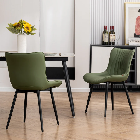 Set of 2 olive drab green faux leather dining chairs with fishtail backrest and metal legs, styled for a modern and mid-century inspired interior.