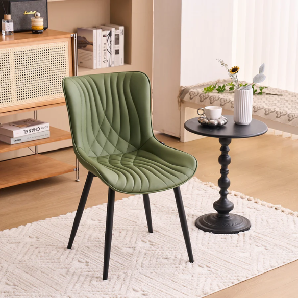 Set of 2 olive drab green faux leather dining chairs with fishtail backrest and metal legs, styled for a modern and mid-century inspired interior.