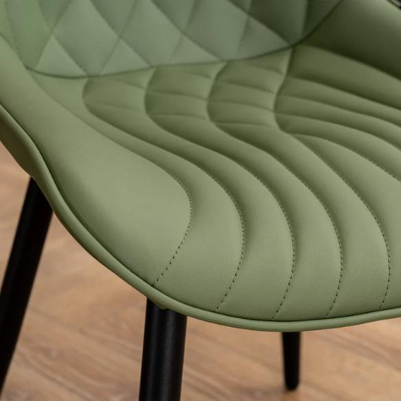 Set of 2 olive drab green faux leather dining chairs with fishtail backrest and metal legs, styled for a modern and mid-century inspired interior.
