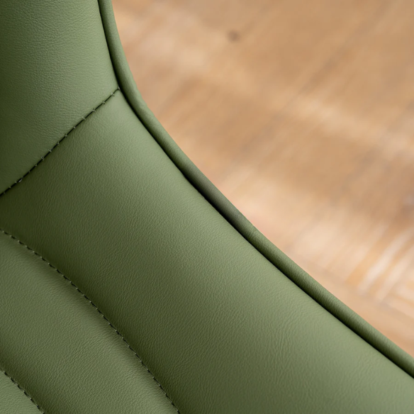 Set of 2 olive drab green faux leather dining chairs with fishtail backrest and metal legs, styled for a modern and mid-century inspired interior.