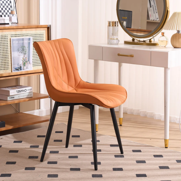 Set of 2 orange faux leather dining chairs with fishtail tufted backs and black metal legs, perfect for modern and colorful dining room settings.