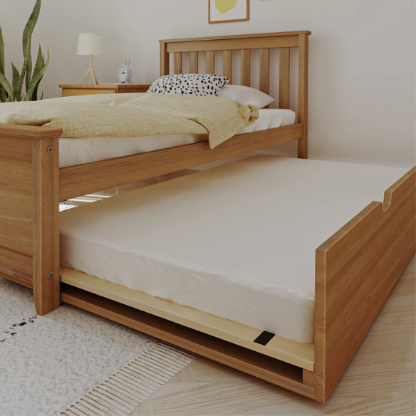 Modern solid wood twin bed with pull-out trundle in pecan finish, featuring slatted headboard and footboard – perfect for kids' rooms and sleepovers.