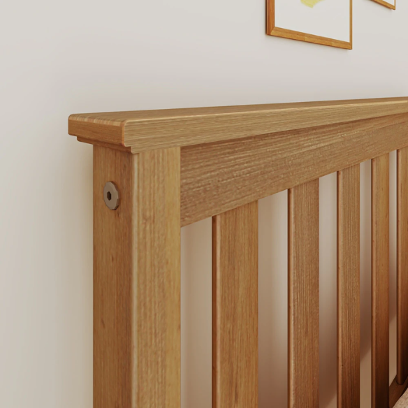 Modern solid wood twin bed with pull-out trundle in pecan finish, featuring slatted headboard and footboard – perfect for kids' rooms and sleepovers.