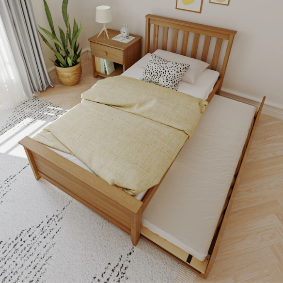Modern solid wood twin bed with pull-out trundle in pecan finish, featuring slatted headboard and footboard – perfect for kids' rooms and sleepovers.