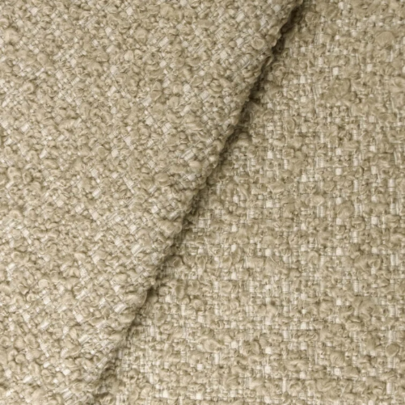 Tan king-size upholstered bed in bouclé fabric with wingback headboard and low-profile black metal legs.