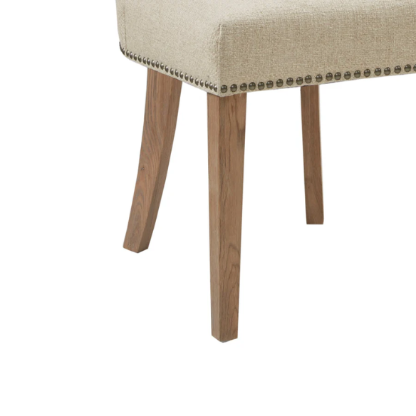 Set of two cream upholstered dining chairs with curved wingback design, dark pewter nailhead trim, and latte wood legs in a traditional style