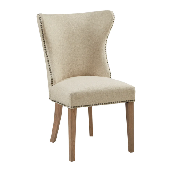 Set of two cream upholstered dining chairs with curved wingback design, dark pewter nailhead trim, and latte wood legs in a traditional style