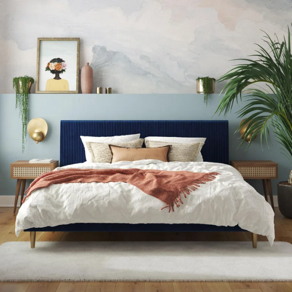 Royal blue velvet king platform bed with tufted rectangular headboard, wood slat support, and sleek low-profile design.