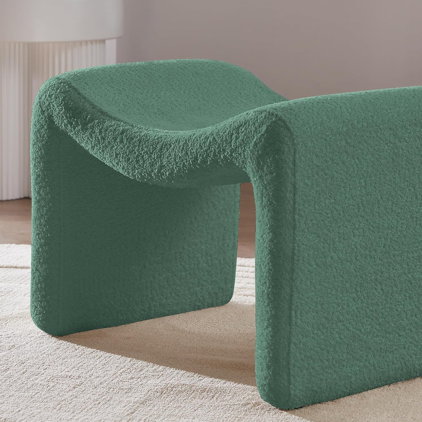 Green bouclé pedal stool with modern semicircular design, engineered wood frame, and soft sherpa fabric, ideal as a footrest or extra seating, perfect for any room.