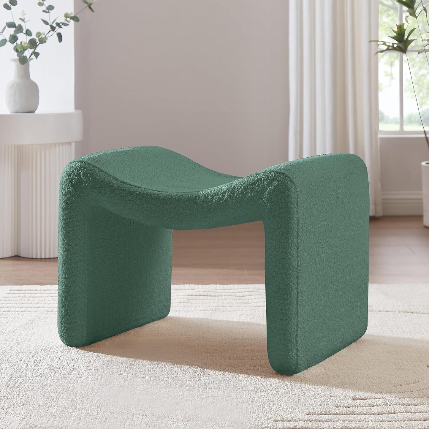 Green bouclé pedal stool with modern semicircular design, engineered wood frame, and soft sherpa fabric, ideal as a footrest or extra seating, perfect for any room.