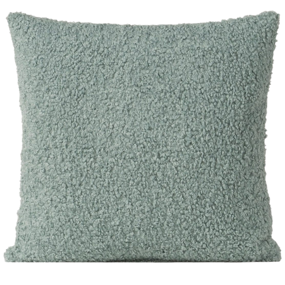 Seafoam green bouclé throw pillow with soft looped texture, square accent pillow on a neutral sofa