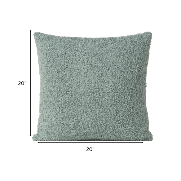 Seafoam green bouclé throw pillow with soft looped texture, square accent pillow on a neutral sofa