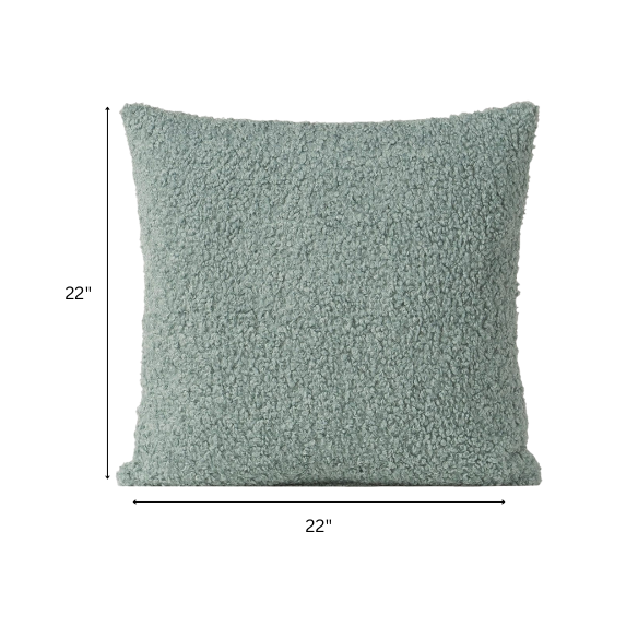 Seafoam green bouclé throw pillow with soft looped texture, square accent pillow on a neutral sofa