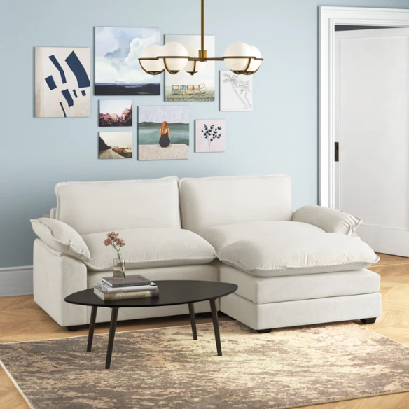 Soft warm cream chenille modular cloud sofa with pillow top arms, deep foam cushions, and matching ottoman