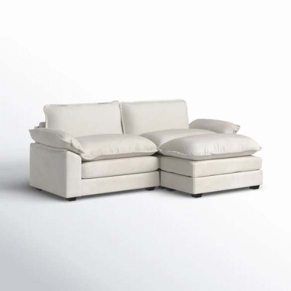Soft warm cream chenille modular cloud sofa with pillow top arms, deep foam cushions, and matching ottoman