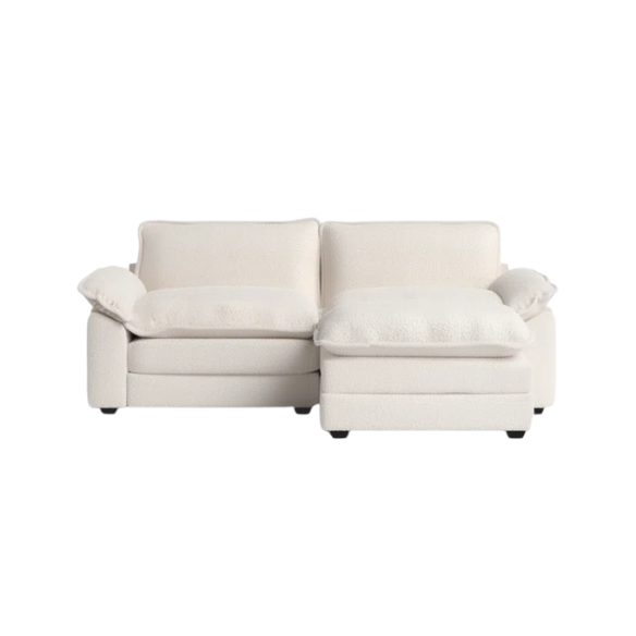 Soft warm cream modular cloud sofa with deep foam cushions, pillow top arms, and a matching free-standing ottoman