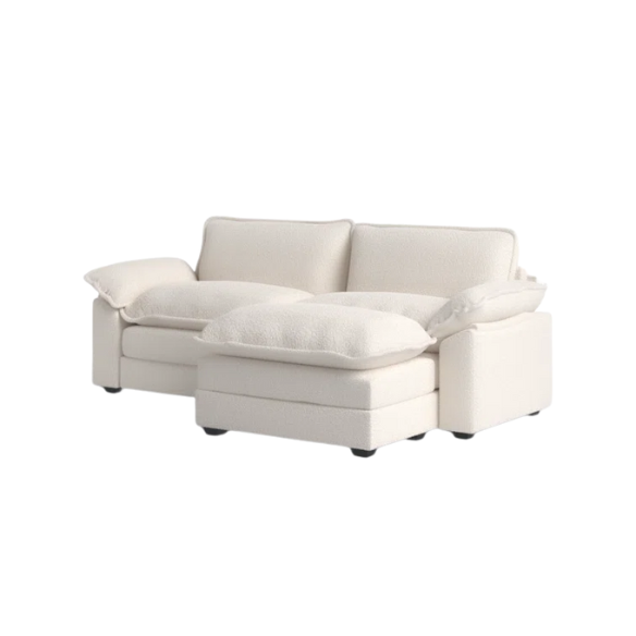 Soft warm cream modular cloud sofa with deep foam cushions, pillow top arms, and a matching free-standing ottoman