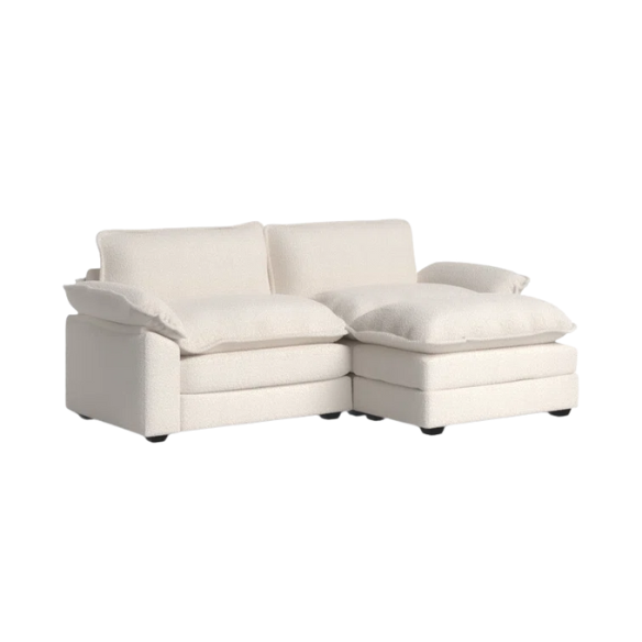 Soft warm cream modular cloud sofa with deep foam cushions, pillow top arms, and a matching free-standing ottoman