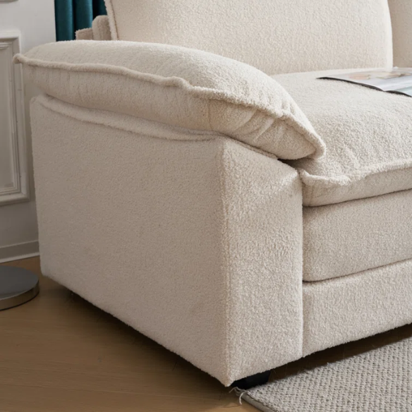 Soft warm cream modular cloud sofa with deep foam cushions, pillow top arms, and a matching free-standing ottoman