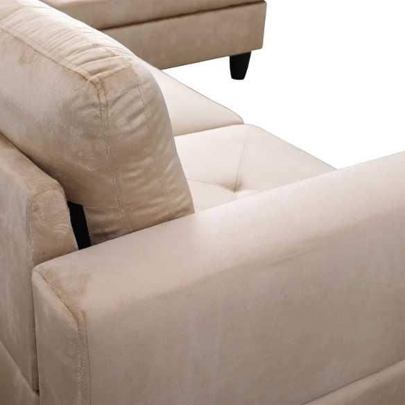 Tan L-shaped sectional sofa with right-facing chaise and ottoman, microfiber upholstery and light gray wooden legs