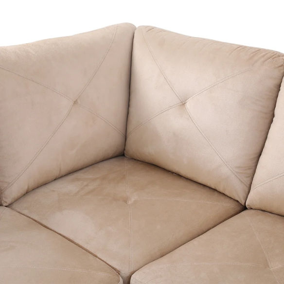 Tan L-shaped sectional sofa with right-facing chaise and ottoman, microfiber upholstery and light gray wooden legs