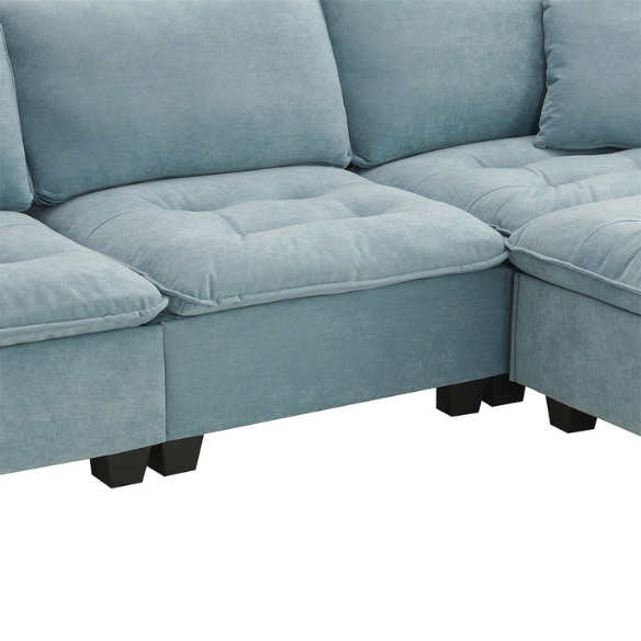 Tranquil sea blue suede L-shaped sectional sofa with tufted seat cushions, reversible chaise, removable ottoman, and two matching throw pillows