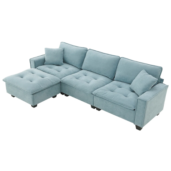Tranquil sea blue suede L-shaped sectional sofa with tufted seat cushions, reversible chaise, removable ottoman, and two matching throw pillows