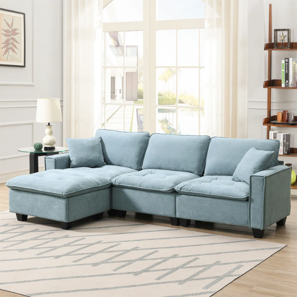 Tranquil sea blue suede L-shaped sectional sofa with tufted seat cushions, reversible chaise, removable ottoman, and two matching throw pillows
