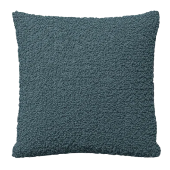 Turquoise bouclé throw pillow with textured loop fabric, square accent pillow on a modern sofa